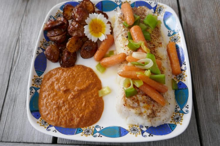 Cod with baked pearl potatoes, butter steamed vegetables and paprika sauce Cod with baked pearl potatoes, butter steamed vegetables and paprika sauce