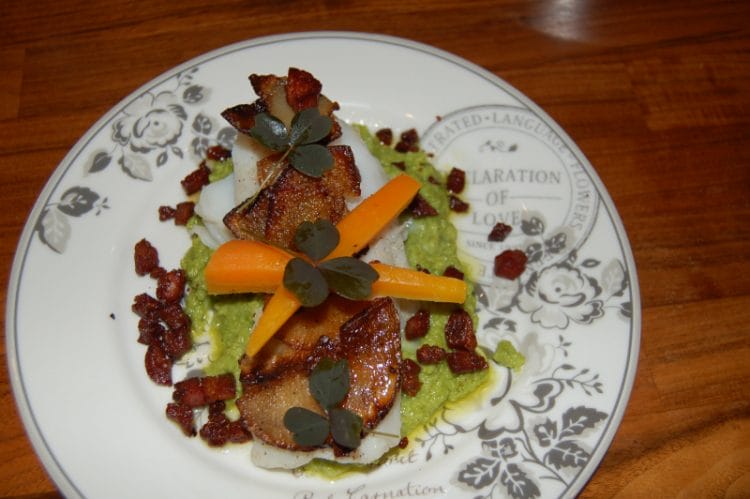 Cod sous vide with raw fried potatoes, glazed carrots, pea puree and bacon