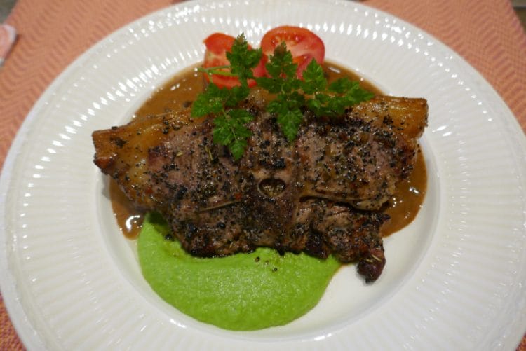 Lamb chops with pea puree and brandy and pepper sauce