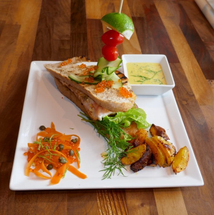 Salmon sandwich with mustard sauce, pickled vegetables and boat potatoes Salmon sandwich with mustard sauce, pickled vegetables and boat potatoes