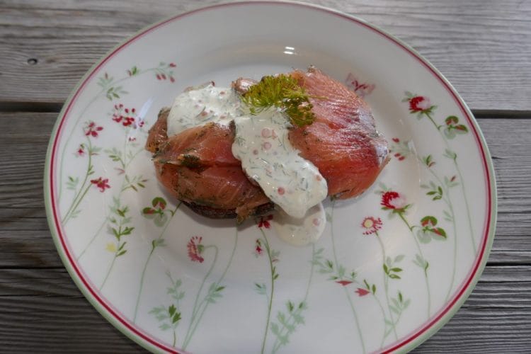 Baked potato with gravlax and cold sour cream sauce