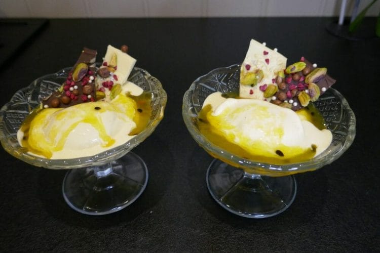 Vanilla ice cream with passion fruit sauce and chocolate decorations
