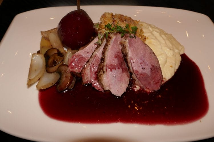 Duck breast with red wine boiled pear, red wine sauce, parsley puree and exciting potatoes