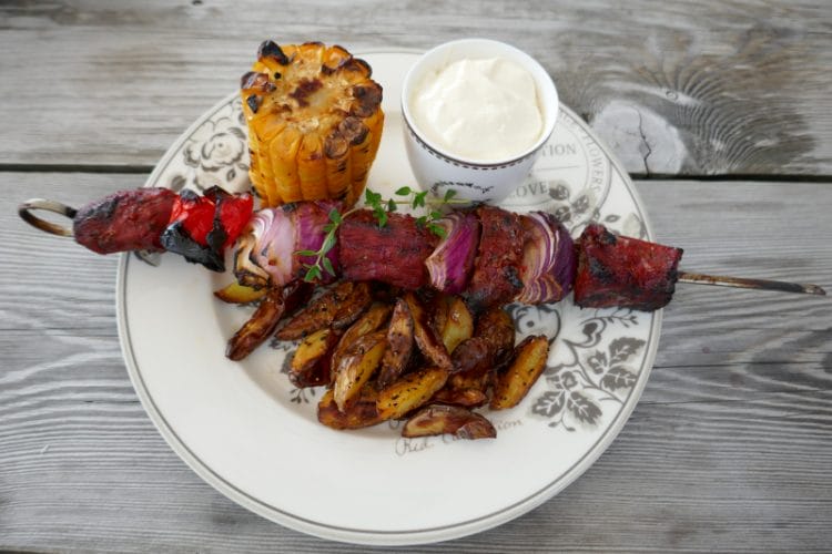 Sweet scorpion barbecue skewers with boat potatoes and aioli