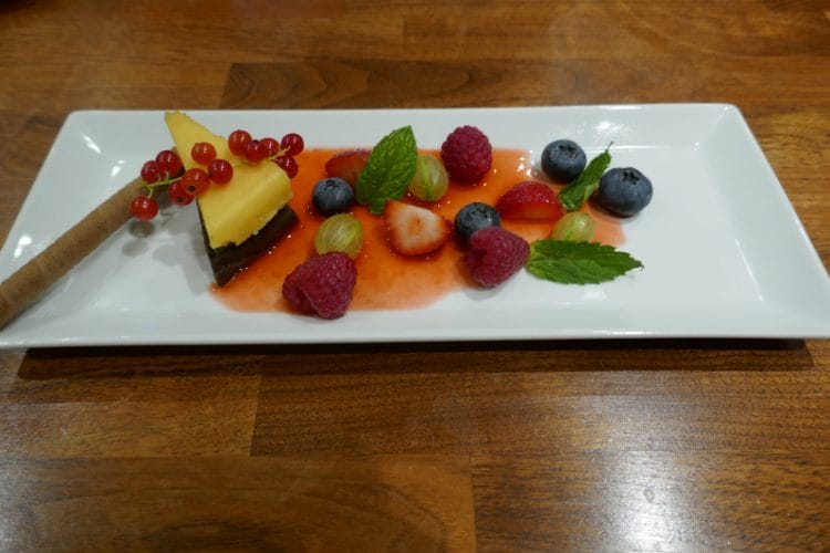 Chocolate terrine with dark and white chocolate with fresh berries and strawberry coulis
